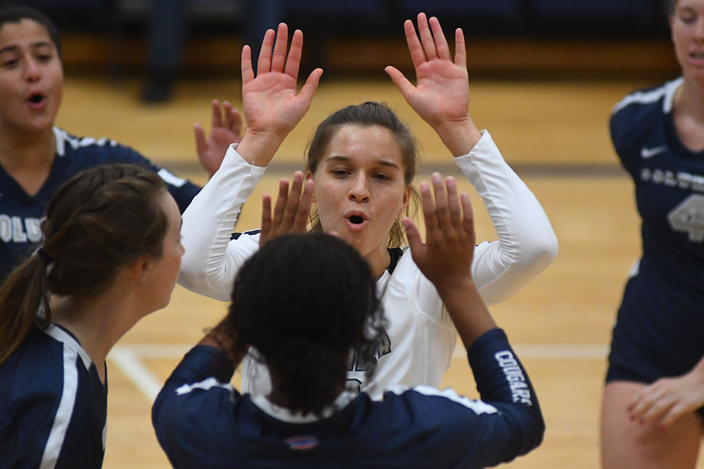 Ellie Rockers celebrates with her teammates after a successful block on Friday